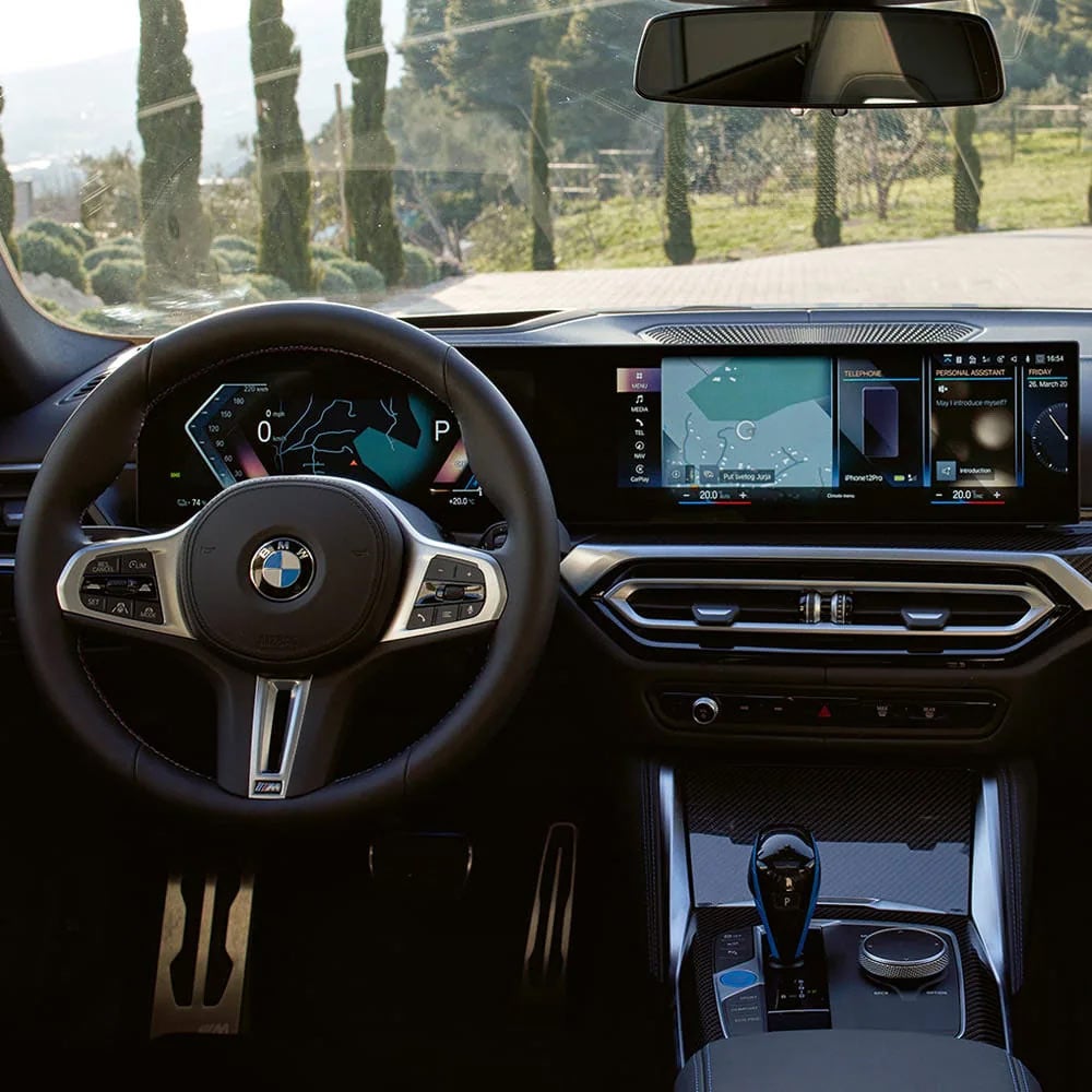 A driver's eye view of steering wheel and controls of the BMW i4 | Leith BMW in Raleigh NC